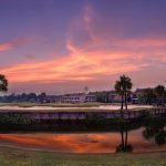 Panoramic view of a lush green golf course at Pelican Point Golf & Country Club. Smooth