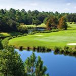 Panoramic view of a lush green golf course at Peninsula Golf & Racquet Club. Smooth