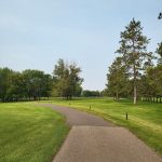 Panoramic view of a lush green golf course at Perham Lakeside Golf Course