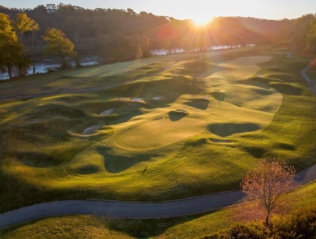 Panoramic view of a lush green golf course at Pete Dye River Course of Virginia Tech. Smooth