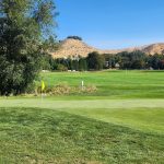 Panoramic view of a lush green golf course at Pierce Park Greens. Smooth