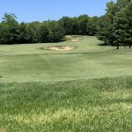 Panoramic view of a lush green golf course at Pilgrim's Run Golf Club. Smooth