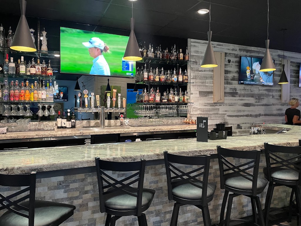 Panoramic view of a lush green golf course at Pin High Indoor Golf. Smooth