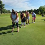 green grass with the flag in the hole.