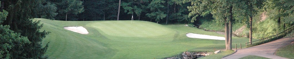 Panoramic view of a lush green golf course at Pine Hills Golf Club. Smooth