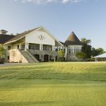 Panoramic view of a lush green golf course at Pine Island Country Club. Smooth