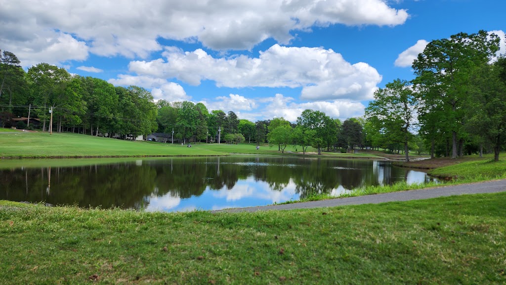 Panoramic view of a lush green golf course at Pine Lake Country Club. Smooth