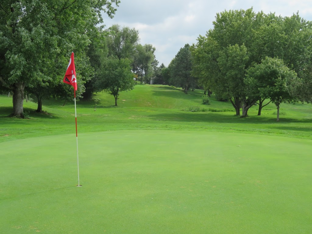 Panoramic view of a lush green golf course at Pine Lake Golf & Tennis. Smooth