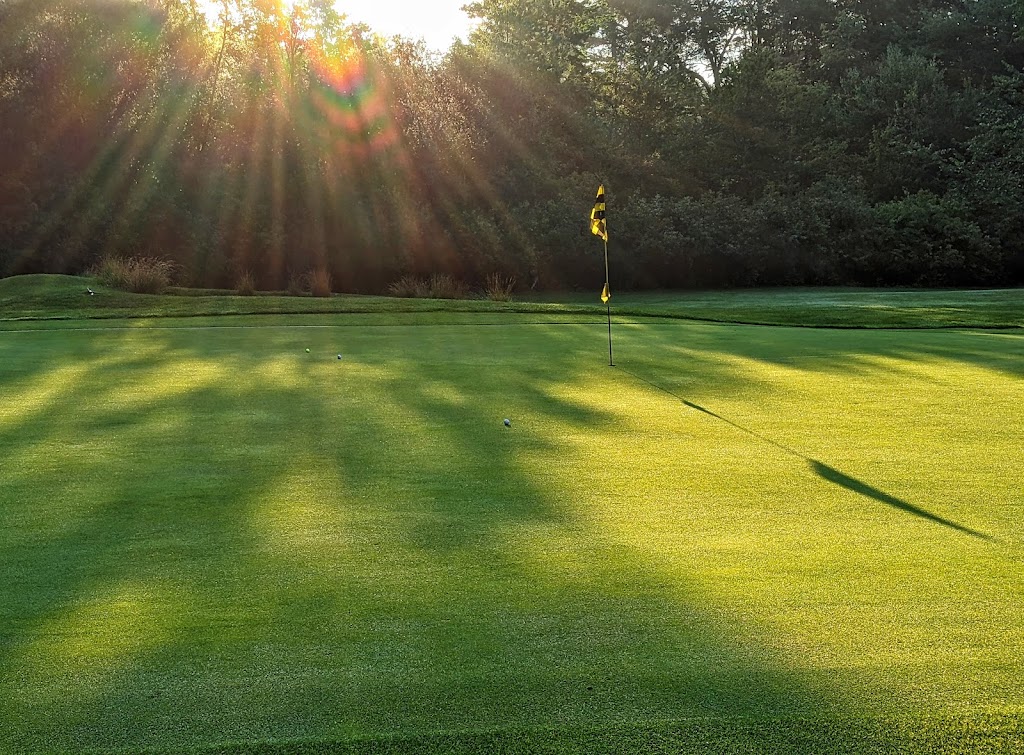 Panoramic view of a lush green golf course at Pine Meadows Golf Club. Smooth