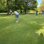 green grass with the flag in the hole.