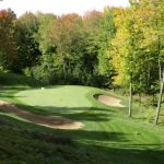 Panoramic view of a lush green golf course at Pine Valley Golf Course. Smooth