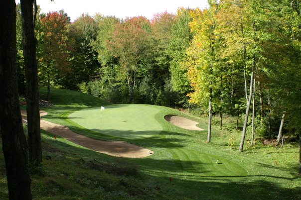 Panoramic view of a lush green golf course at Pine Valley Golf Course. Smooth