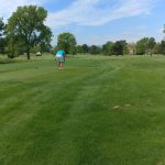 green grass with the flag in the hole.