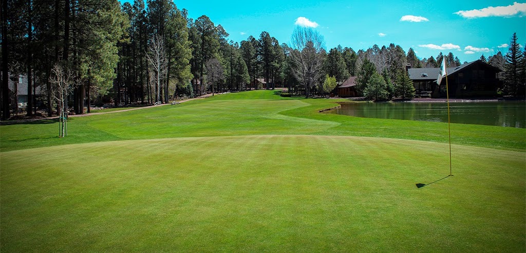 Panoramic view of a lush green golf course at Pinetop Lakes Country Club. Smooth