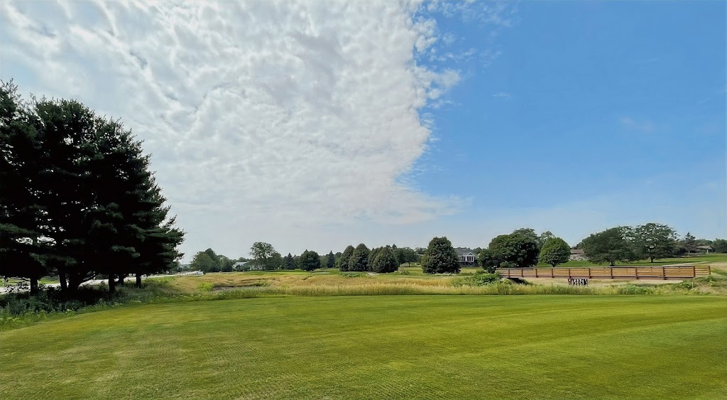 Panoramic view of a lush green golf course at Pioneer Pointe Golf Course. Smooth