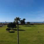 Panoramic view of a lush green golf course at Pismo Beach Golf Course. Smooth