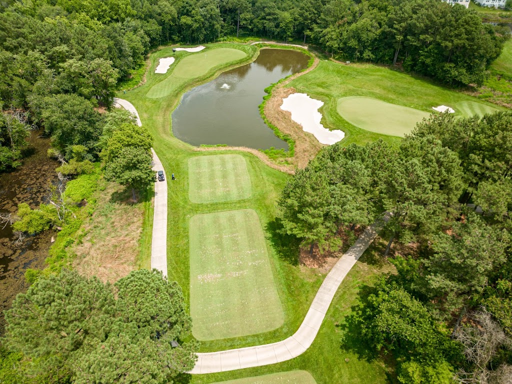 Panoramic view of a lush green golf course at Plantation Lakes Golf & Country Club. Smooth