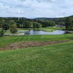 Panoramic view of a lush green golf course at Pleasant Valley Golf Club. Smooth