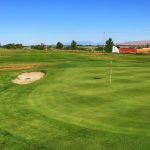 Panoramic view of a lush green golf course at Pleasant Valley Golf Course. Smooth