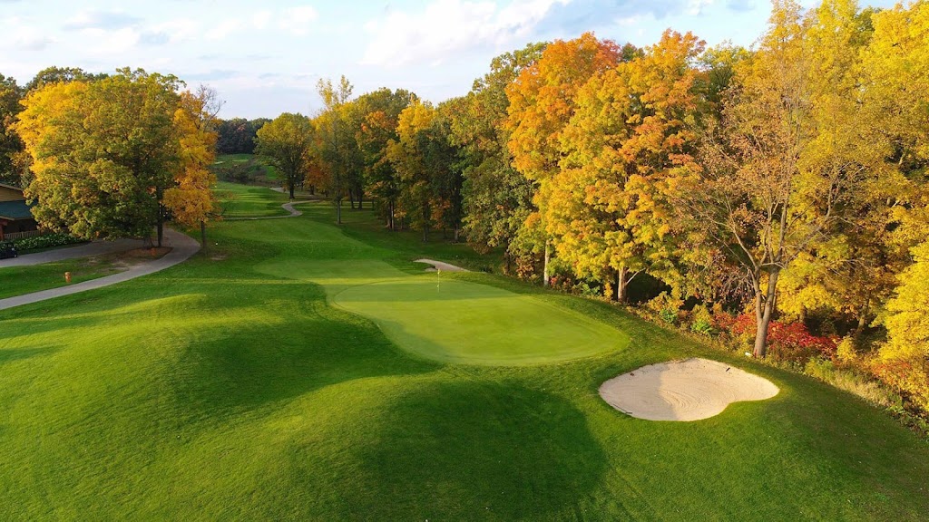 Panoramic view of a lush green golf course at PohlCat Golf Course. Smooth