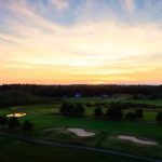 Panoramic view of a lush green golf course at Point Sebago Golf Course. Smooth