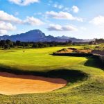 Panoramic view of a lush green golf course at Poipu Bay Golf Course. Smooth