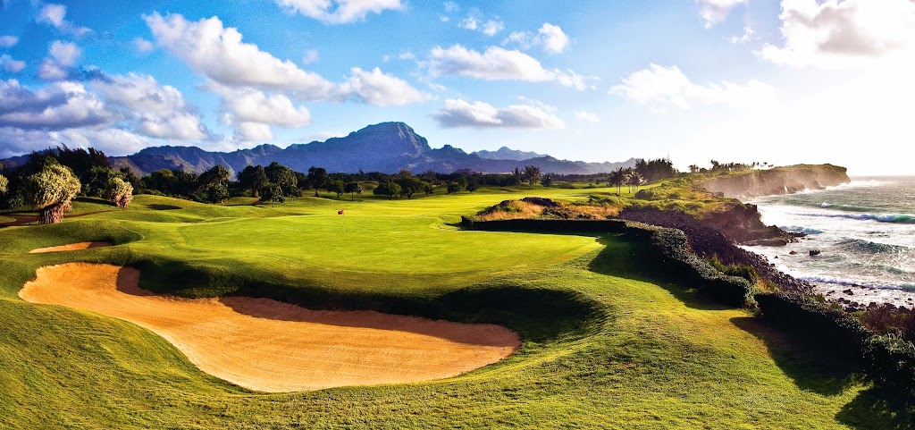 Panoramic view of a lush green golf course at Poipu Bay Golf Course. Smooth