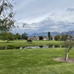 Panoramic view of a lush green golf course at Polson Bay Golf Course. Smooth