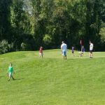 Panoramic view of a lush green golf course at Ponemah Green Family Golf Center. Smooth