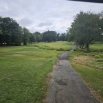 Panoramic view of a lush green golf course at Poquoy Brook Golf Club. Smooth