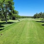 Panoramic view of a lush green golf course at Prairie Dog Golf Course. Smooth