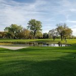 Panoramic view of a lush green golf course at Prairiewood Golf Course. Smooth