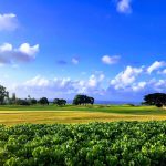 Panoramic view of a lush green golf course at Princeville at Hanalei. Smooth