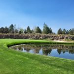 Panoramic view of a lush green golf course at Pronghorn Golf Club. Smooth