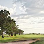 Panoramic view of a lush green golf course at Prouts Neck Country Club. Smooth