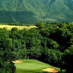 Panoramic view of a lush green golf course at Puakea Golf Course. Smooth