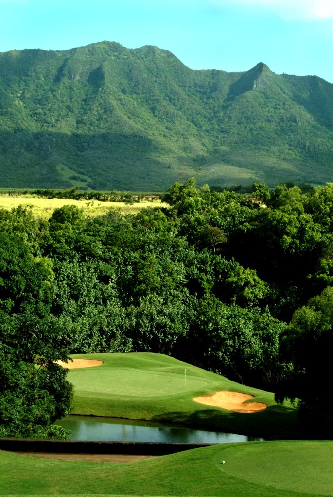 Panoramic view of a lush green golf course at Puakea Golf Course. Smooth