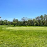 Panoramic view of a lush green golf course at Quail Creek Golf Club. Smooth