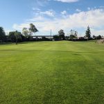 Panoramic view of a lush green golf course at Rancho del Pueblo Golf Course. Smooth