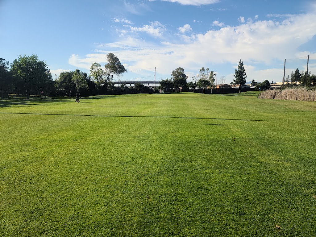 Panoramic view of a lush green golf course at Rancho del Pueblo Golf Course. Smooth