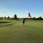 green grass with the flag in the hole.