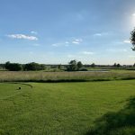 Panoramic view of a lush green golf course at Redfield Golf Course. Smooth