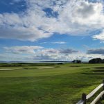 Panoramic view of a lush green golf course at Rhode Island Country Club. Smooth