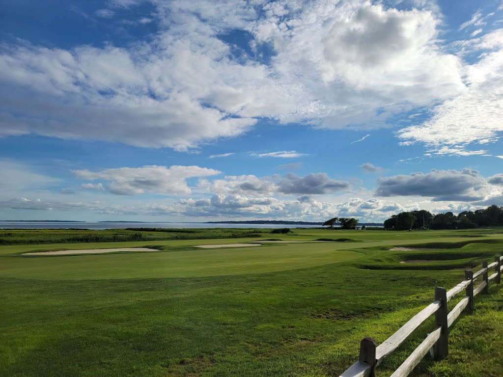 Panoramic view of a lush green golf course at Rhode Island Country Club. Smooth