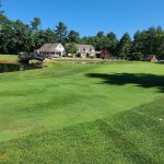 Panoramic view of a lush green golf course at Richmond Country Club. Smooth