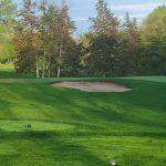 Panoramic view of a lush green golf course at Ridges At Sand Creek. Smooth