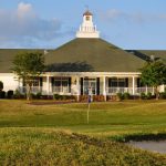 Panoramic view of a lush green golf course at River Bend Links. Smooth