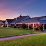 Panoramic view of a lush green golf course at River Oaks Golf Club. Smooth