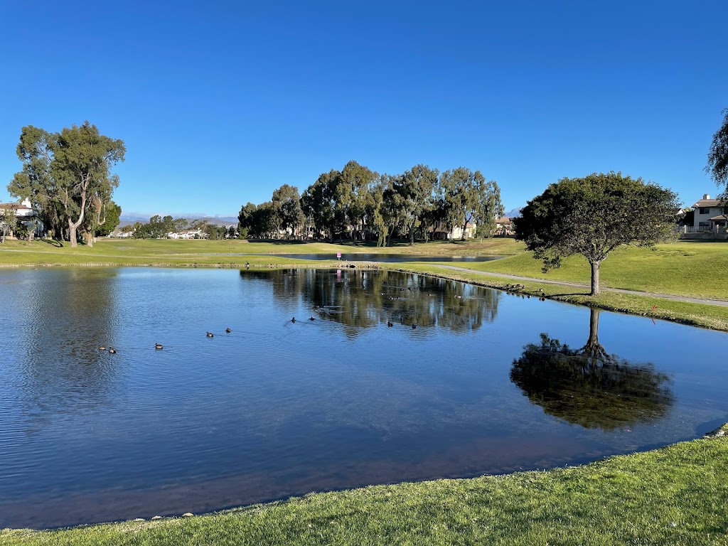 Panoramic view of a lush green golf course at River Ridge Golf Club. Smooth