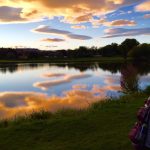 Panoramic view of a lush green golf course at River Ridge Golf Course. Smooth